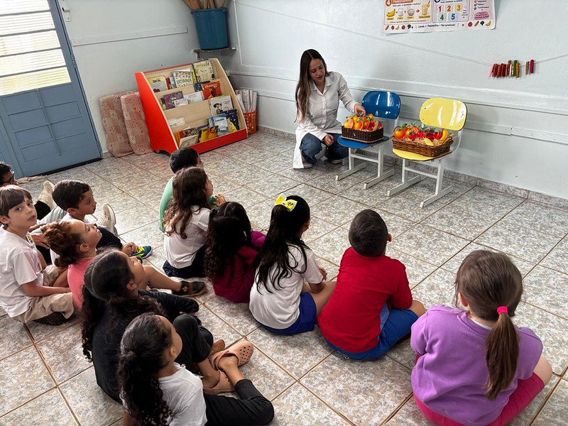 Estudantes da rede municipal de Educação de Americana participam da "Avaliação Nutricional e Promoção da Educação Alimentar e Nutricional no Ambiente Escolar", realizada esta semana em 13 escolas vinculadas à Prefeitura. A ação é desenvolvida em parceria entre a Secretaria de Educação e a FAM (Faculdade de Americana), por meio do curso de graduação em Nutrição. A atividade inclui a aferição de peso, estatura e análise do consumo alimentar para diagnóstico do estado nutricional dos estudantes e a realização de oficinas e dinâmicas pedagógicas adaptadas à faixa etária das crianças e adolescentes e integradas à matriz curricular. As seguintes escolas municipais aderiram à proposta: Casas da Criança Aracy, Panamby, Tahira, Juriti, Arapiranga, Pitanga, Urupê e Araúna, Escolas Municipais de Educação Infantil (EMEIs) Aracati, Ceci e Cunhataí e Escolas Municipais de Ensino Fundamental (EMEFs) Darcy Ribeiro e Milton Santos. As intervenções são conduzidas nas escolas municipais por docentes e estudantes do Curso de Nutrição da FAM, sob supervisão técnica de nutricionistas vinculadas à secretaria, e estão em consonância com as diretrizes do Programa Nacional de Alimentação Escolar (PNAE) e com a Base Nacional Comum Curricular (BNCC). A ação integra a programação da 8ª Edição da Jornada de Educação Alimentar e Nutricional (EAN), iniciativa nacional promovida pelo Fundo Nacional de Desenvolvimento da Educação (FNDE), vinculado ao Ministério da Educação (MEC). "O trabalho na Educação municipal vai muito além da sala de aula e inclui também o cuidado com a alimentação e a nutrição das crianças e adolescentes matriculadas em nossas escolas. Por este ser um tema intimamente ligado ao bem-estar dos estudantes, estamos felizes com esta parceria que traz novos conhecimentos e contribui para o desenvolvimento pedagógico de cada um", disse o secretário de Educação, Vinicius Ghizini.